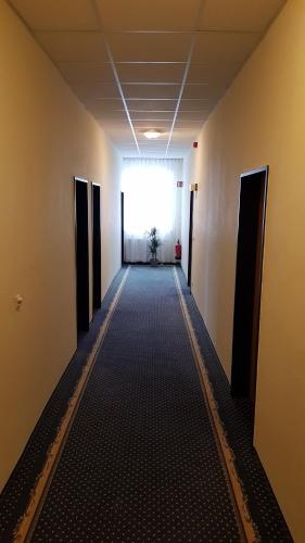 a hallway of an office building with a window at Hotel Altberesinchen in Frankfurt/Oder