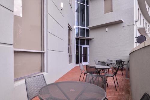 a patio with tables and chairs in a building at Holiday Inn Express New Orleans - Arts District by IHG in New Orleans