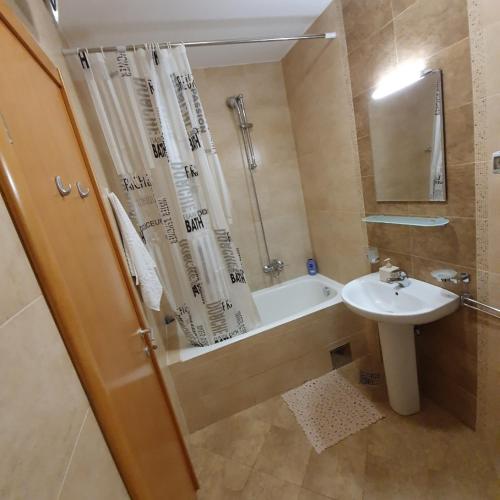 a bathroom with a tub and a sink and a shower at Aphrodite Apartment in Podgorica