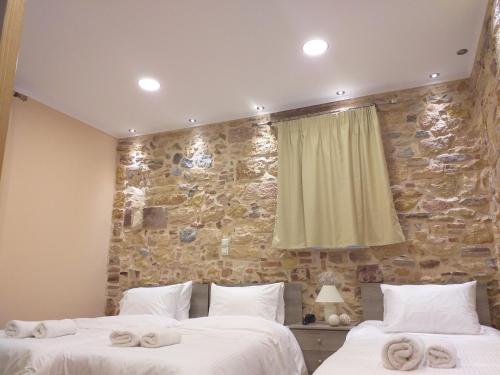 a bedroom with two beds with towels on them at CityZen Rooms Chios in Chios