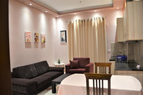 a living room with a couch and a table at Comfort Apartments in Fier