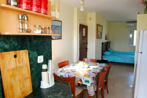 a dining room with a table with a candle on it at NEVE ZOHAR DEAD SEA in Neve Zohar