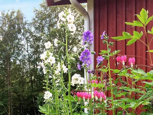 a bunch of flowers in front of a building at 4 person holiday home in TORUP in Torup