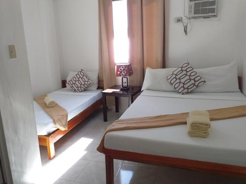 Postel nebo postele na pokoji v ubytování Zenith Inn & Resto Bar