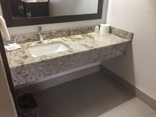 a bathroom counter with a sink and a mirror at Motel 6-Burnsville, MN in Burnsville
