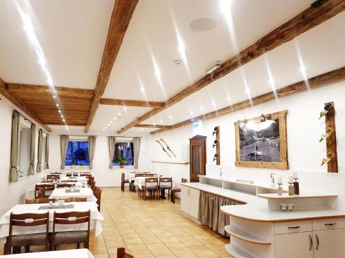 a restaurant with tables and chairs in a room at Zirbenhof in Innerkrems