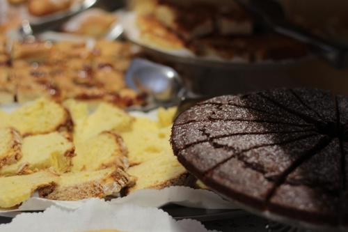 a plate of food with a pizza and a cookie at Hotel Carezza in Cervia