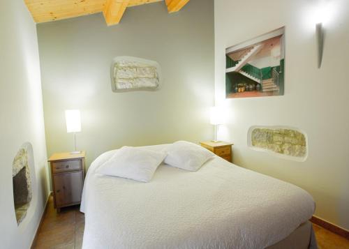a bedroom with a white bed and two lamps at Casa Cristina Bed&Breakfast in Ripabottoni