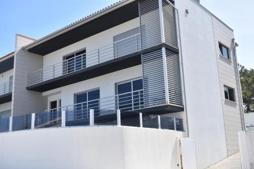 a white building with balconies on it at Casa da Vitoria in Falca