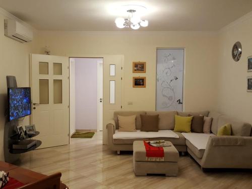 a living room with a couch and a table at Holiday Center Apartment in Shkodër