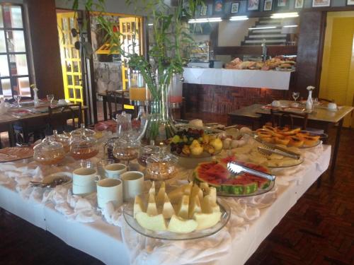 a buffet of food on a table in a restaurant at Hotel El Cazar in Búzios