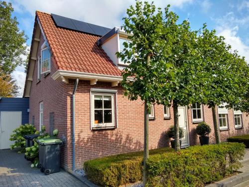 a red brick house with a solar roof at Folmerhuis in Oostkapelle