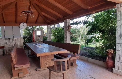 a large wooden table and chairs on a patio at Apartment Krajacic in Krk
