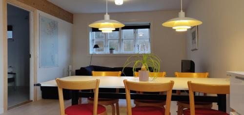 a kitchen and dining room with a table and chairs at Bed & Breakfast Torshavn in Tórshavn
