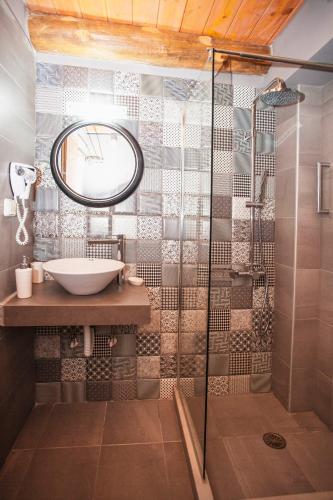 a bathroom with a sink and a shower at Ariadne Traditional Home in Margarítai