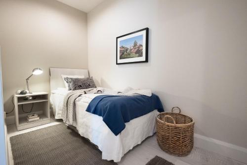 a bedroom with a bed and a picture on the wall at Sands Hotell in Sandhamn