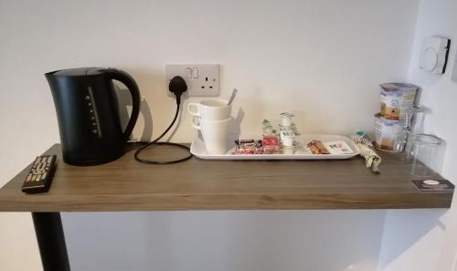 a table with a plate of food on it at Boleyn house in Bodmin
