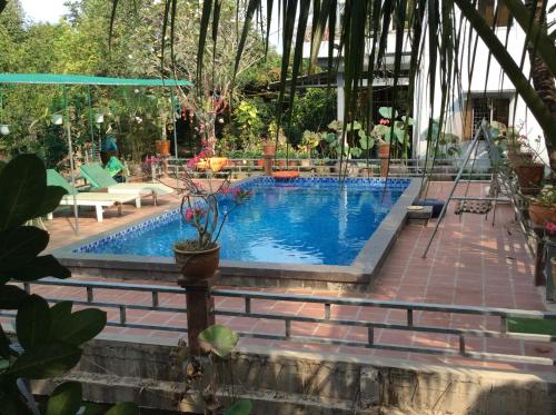 a swimming pool in the middle of a yard at Quoc Phuong Riverside Homestay in Ben Tre