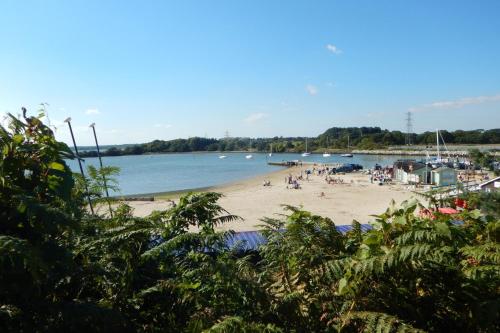a beach with a bunch of people on it at Pine Ridge 59 Rockley Park Poole with sea view sleeps six in Poole