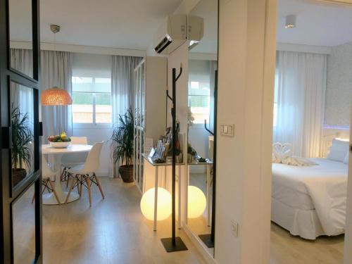 a bedroom with a bed and a table and a desk at Casa Fuerte Playa in La Herradura