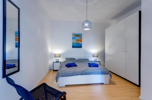 a bedroom with a bed and a chair at Apartment with Stunning Seaviews in Sliema
