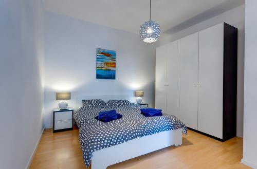 a bedroom with a bed with blue pillows on it at Apartment with Stunning Seaviews in Sliema