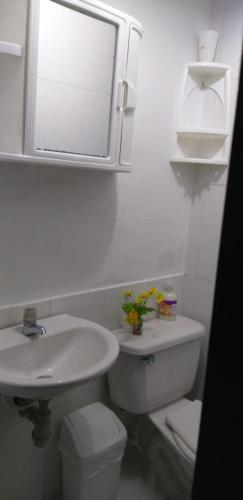 biała łazienka z umywalką i toaletą w obiekcie CENTRO! San Lorenzo - Downtown - Apto con 2 Hab & Parqueadero w mieście Medellín