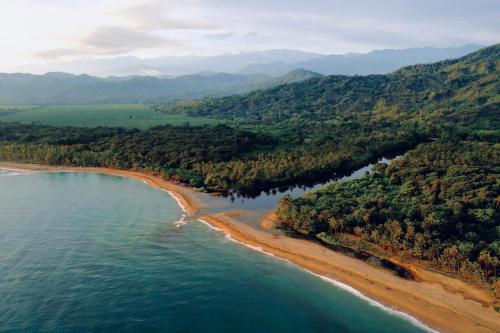 an aerial view of the shoreline of a beach at Bohemia Beach Tayrona in Guachaca