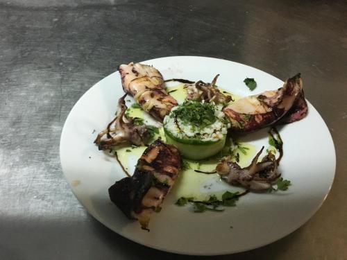a white plate of food on a table at Hotel Achillion in Makrýgialos