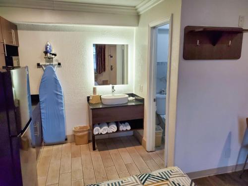 a bathroom with a sink and a mirror at Studio 6-National City, CA - Naval Base San Diego in National City