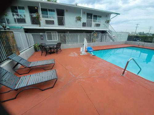 a patio with two chairs and a swimming pool at Studio 6-National City, CA - Naval Base San Diego in National City