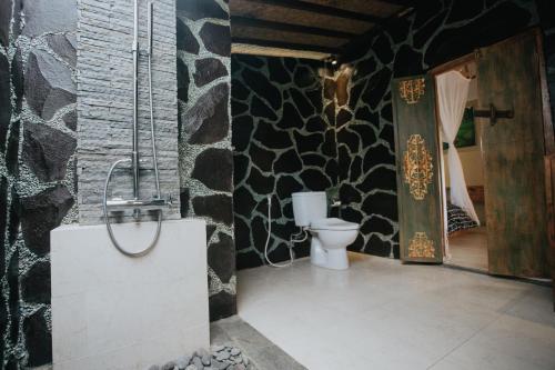 a bathroom with a sink and a toilet in a room at Yoga Maya Villa in Gianyar