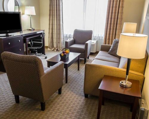 a living room with a couch and chairs in a hotel room at Comfort Suites University Area Notre Dame-South Bend in South Bend