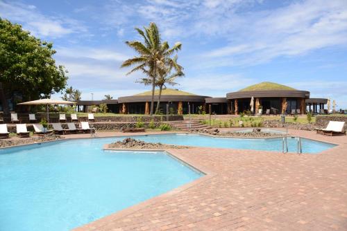 a resort with a swimming pool and a building at Nayara Hangaroa in Hanga Roa