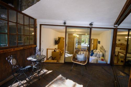 a room with chairs and a table and a bedroom at Villa Toscana ValQuirico Lofts & Suites Hotel Boutique in Santeagueda