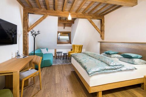 a bedroom with a bed and a table and chairs at Kaštieľ Kubínyi in Dolný Kubín