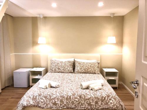 a bedroom with a large bed with two pillows at Borgo Empedocle House in Catania