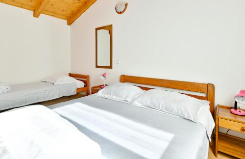 a bedroom with two beds and a mirror at Adriatico Bungalow in Poreč