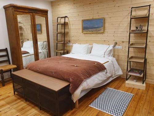 a bedroom with a bed in a room with wooden walls at LE 41 AVENUE FOCH in Luchon