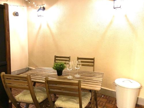 a table with wine glasses and a potted plant on it at Borgo Empedocle House in Catania