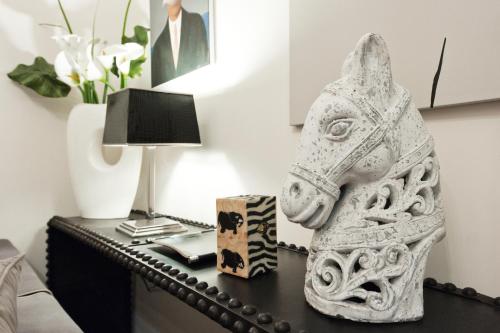 a table with a statue of a horse on it at Casa Roma Luxury Apartment in Rome