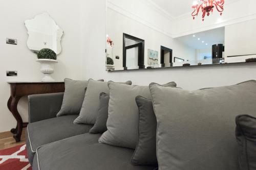 a couch with pillows in a living room at Casa Roma Luxury Apartment in Rome