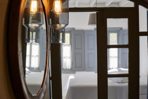 a room with a mirror and a bed in a room at 9 Muses Exclusive Apartments in Grikos