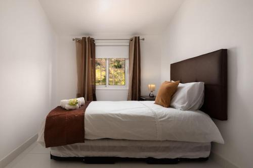 a bedroom with a large bed and a window at Casa Santana in Estreito da Calheta