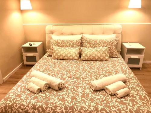 a bedroom with a large bed with four pillows at Borgo Empedocle House in Catania