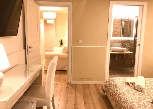 a room with a bathroom with a bed and a sink at Borgo Empedocle House in Catania