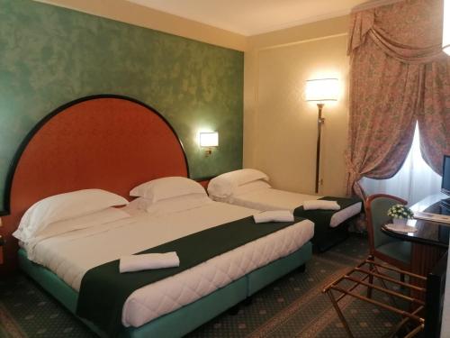 Postel nebo postele na pokoji v ubytování Hotel Principe