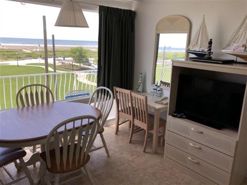 a kitchen and dining room with a table and a television at Cara Mara Resort in Wildwood Crest