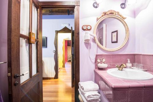 a bathroom with a sink and a mirror at Casa A Laxe in O Pindo