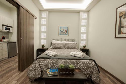 a bedroom with a large bed and a table at ¨Socrates¨ Traditional Apartment In The Center Of Athens in Athens
